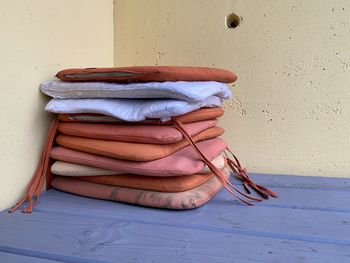 Stack of shoes on table against wall