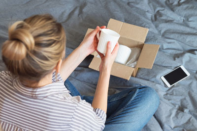 Rear view of woman sitting in box