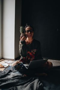 Woman using laptop while siting at home