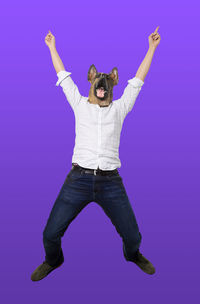 Portrait of man standing against blue background