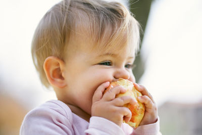 Close-up portrait of cute boy eating food