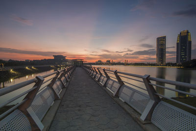 Bridge over putrajaya lake against sky during sunset