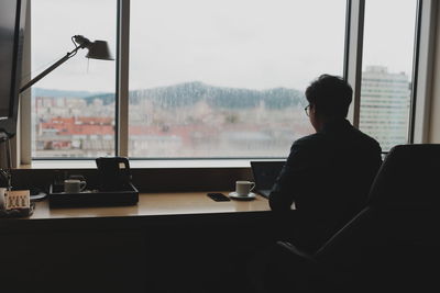 Businessman using laptop while sitting in office