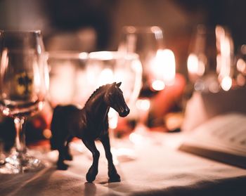 Close-up of horse figurine on table