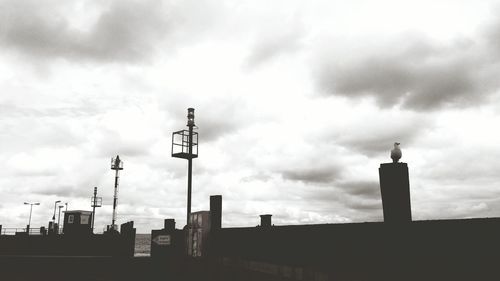 Low angle view of silhouette buildings against sky