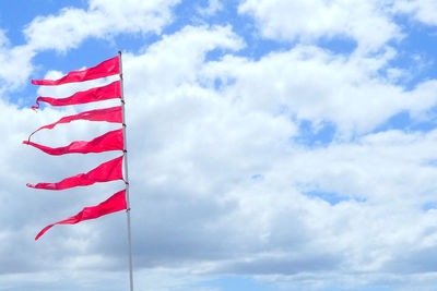 Low angle view of flag against sky