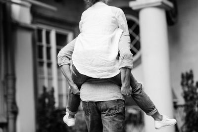 Rear view of woman walking on street