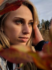 Close-up portrait of young woman looking away