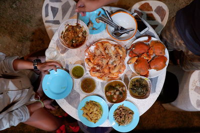 High angle view of woman having food on table