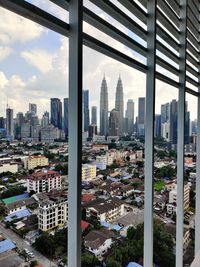 High angle view of buildings in city against sky