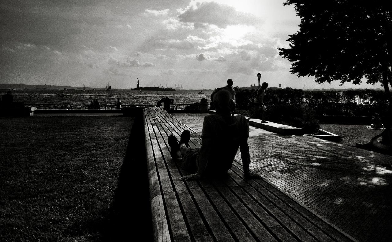 sky, rear view, lifestyles, full length, leisure activity, togetherness, men, railing, walking, the way forward, cloud - sky, bonding, cloud, casual clothing, person, boys, love