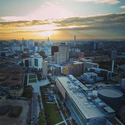 High angle view of modern buildings against sky during sunset