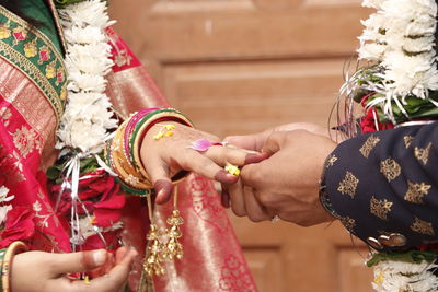 Midsection of bride and groom