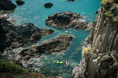 High angle view of people kayaking on sea