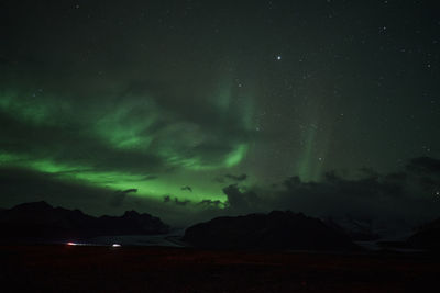 Scenic view of mountains against sky at night