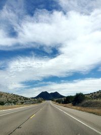 Empty road along countryside landscape