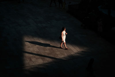 High angle view of woman walking on street