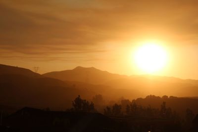 Scenic view of silhouette mountains against sky during sunset