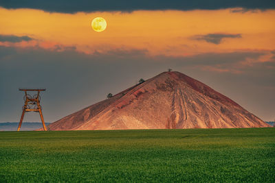 Scenic view of field against sky during sunset