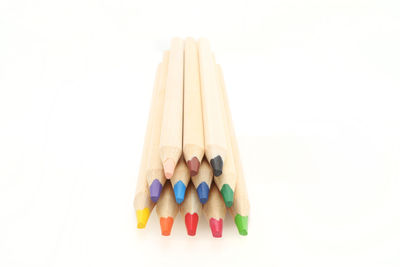 Close-up of multi colored pencils against white background