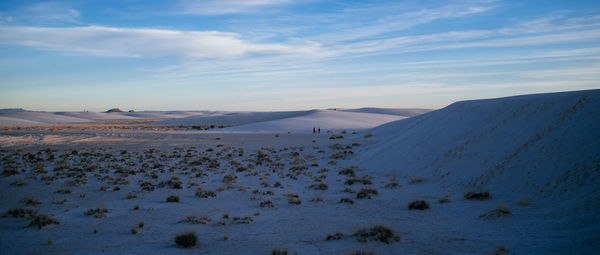 Scenic view of snow covered land against sky