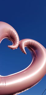 Low angle view of swimming pool against blue sky