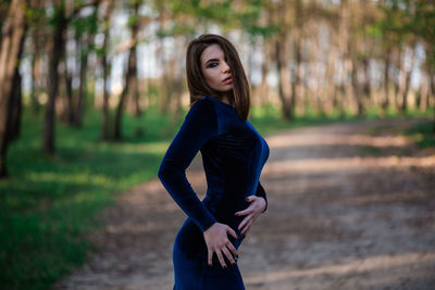 Portrait of beautiful woman standing on land