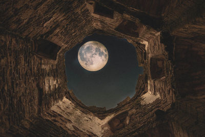 Low angle view of moon in sky at night