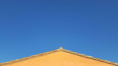 Low angle view of building against blue sky