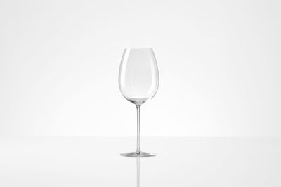 Close-up of wineglass against white background
