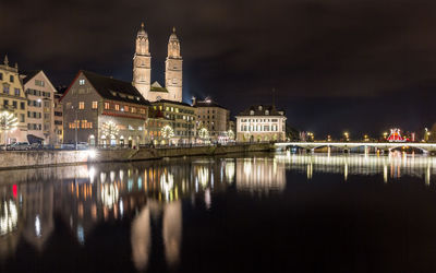 Reflection of illuminated buildings in city at night