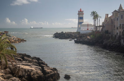 Scenic view of sea and buildings against sky