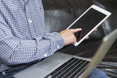 Midsection of man using mobile phone