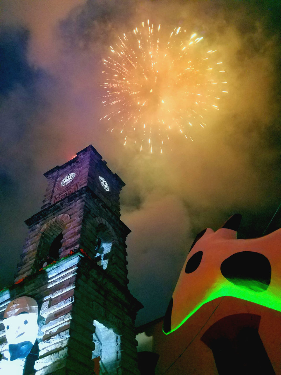 LOW ANGLE VIEW OF FIREWORK DISPLAY AT NIGHT