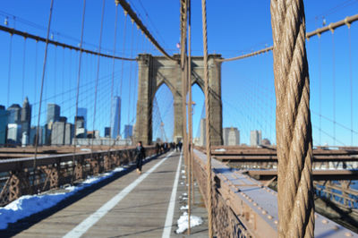 Brooklyn bridge against clear blue sky during sunny day