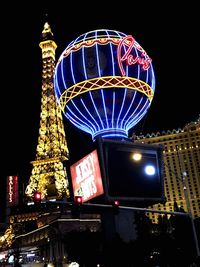 Illuminated ferris wheel at night