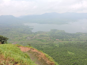 Scenic view of field and mountains against sky