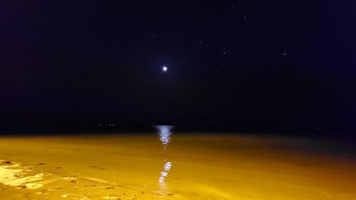 Scenic view of moon in city at night