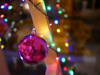 Close-up of illuminated christmas lights hanging from tree
