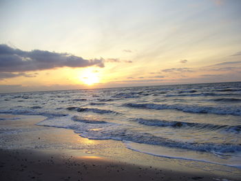 Scenic view of beach against sky during sunset