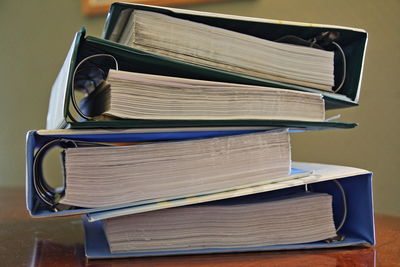 Close-up of stacked files on table