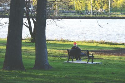 Man sitting on tree trunk in park