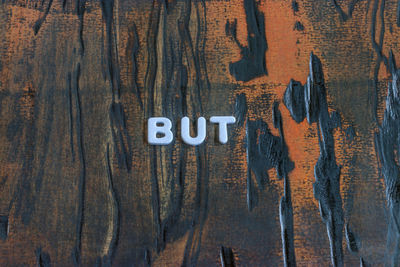 Directly above shot of text on wooden plank