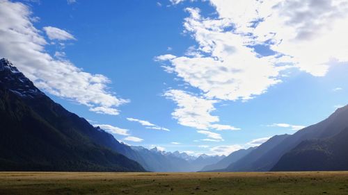 Scenic view of landscape and mountains against sky