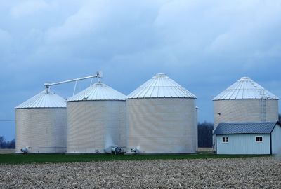 Barn on field against sky