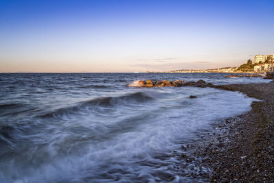 Scenic view of sea against clear sky during sunset