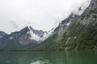 Scenic view of lake and mountains against sky