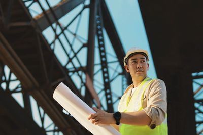 Portrait of young man standing against sky