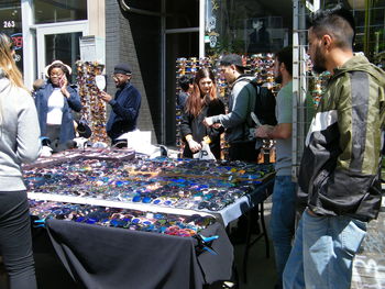 Group of people at market stall in city