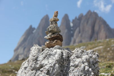 Low angle view of rocks on mountain against sky